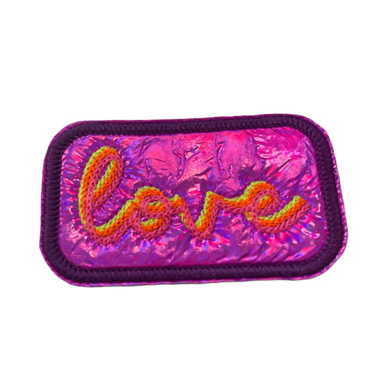 LOVE patch with neon yellow, neon orange, and neon pink chain stitch on bright pink holographic vinyl.