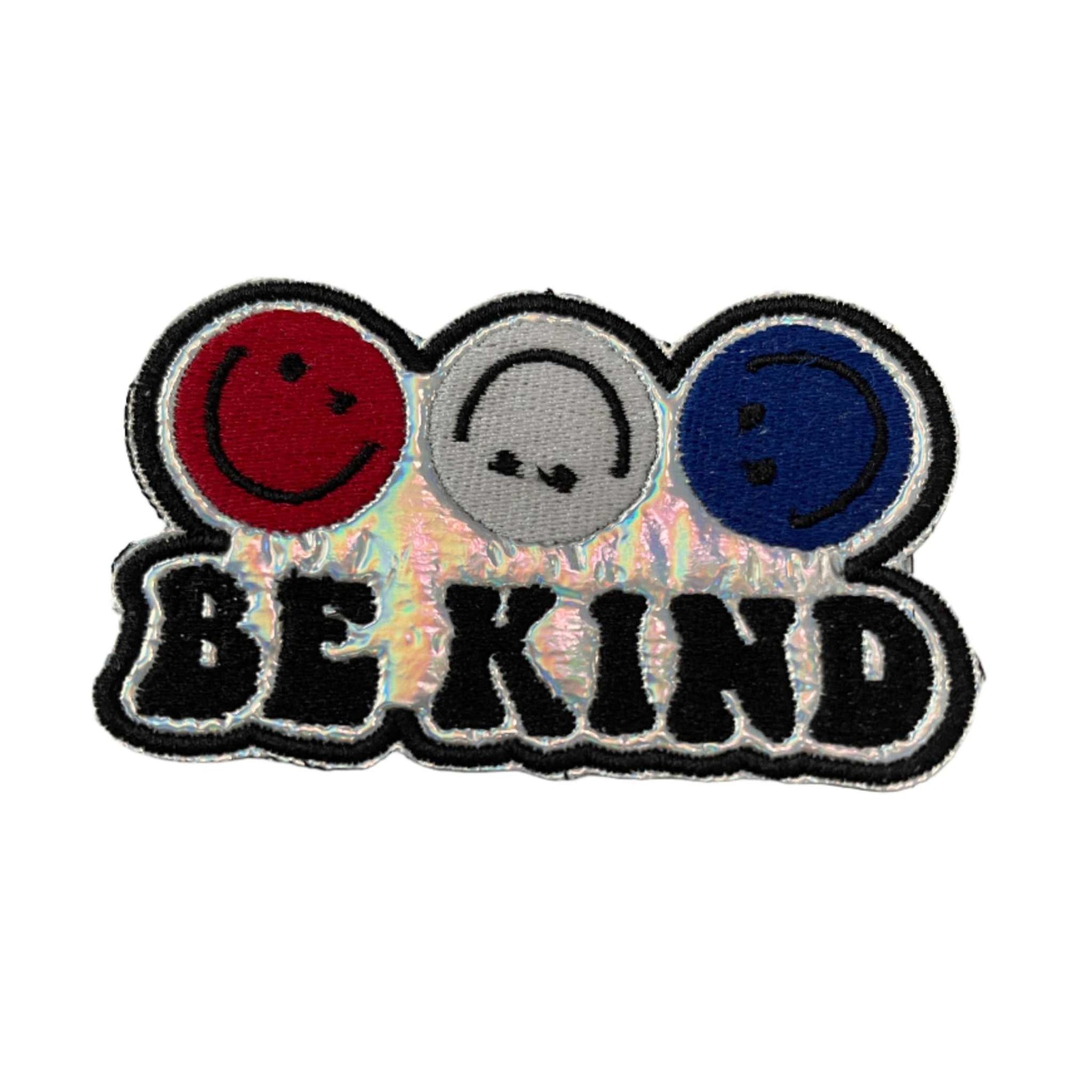 Handmade Be Kind iron-on patch with red, white, blue smiley faces on holographic silver background.