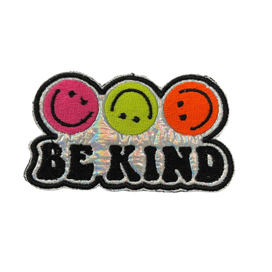 Handmade Be Kind iron-on patch with neon pink, yellow, orange smiley faces on holographic silver background.