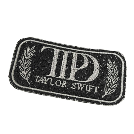 Taylor Swift Tortured Poets Department iron-on patch with black and white "TPD" design.