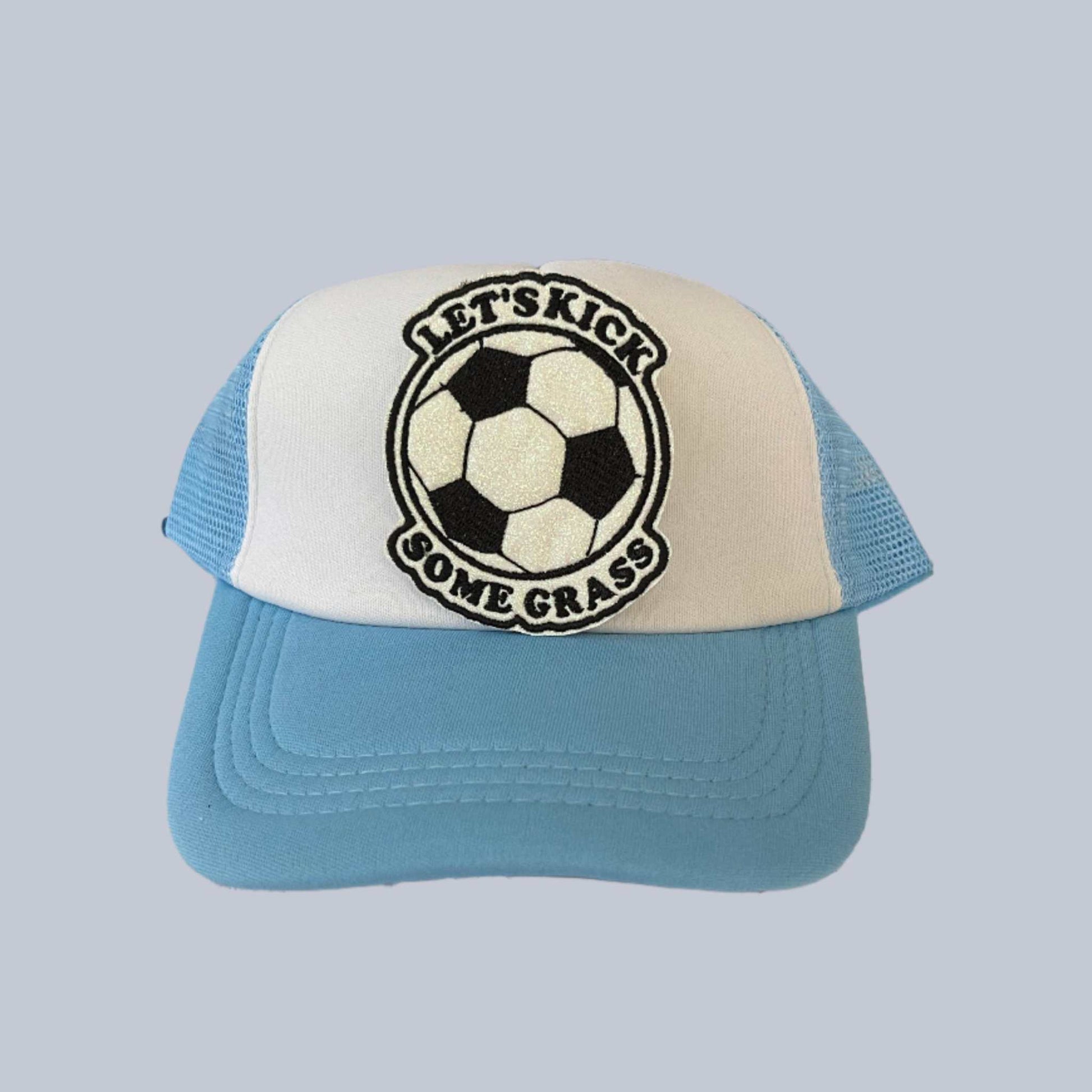 Handmade iron-on patch featuring a classic black and white soccer ball with the text "Let's Kick Some Grass," perfect for adding to clothing, bags, or hats.