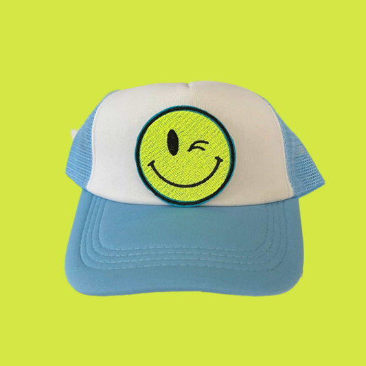 Iron-on patch featuring a bright yellow winking smiley face, showcasing a playful and retro aesthetic.