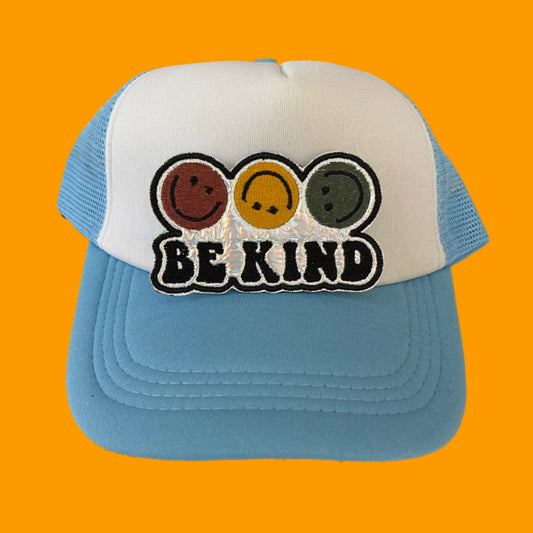 Iron-on patch featuring four smiley faces in red, yellow, orange, and green with the phrase "BE KIND" on a holographic silver background.