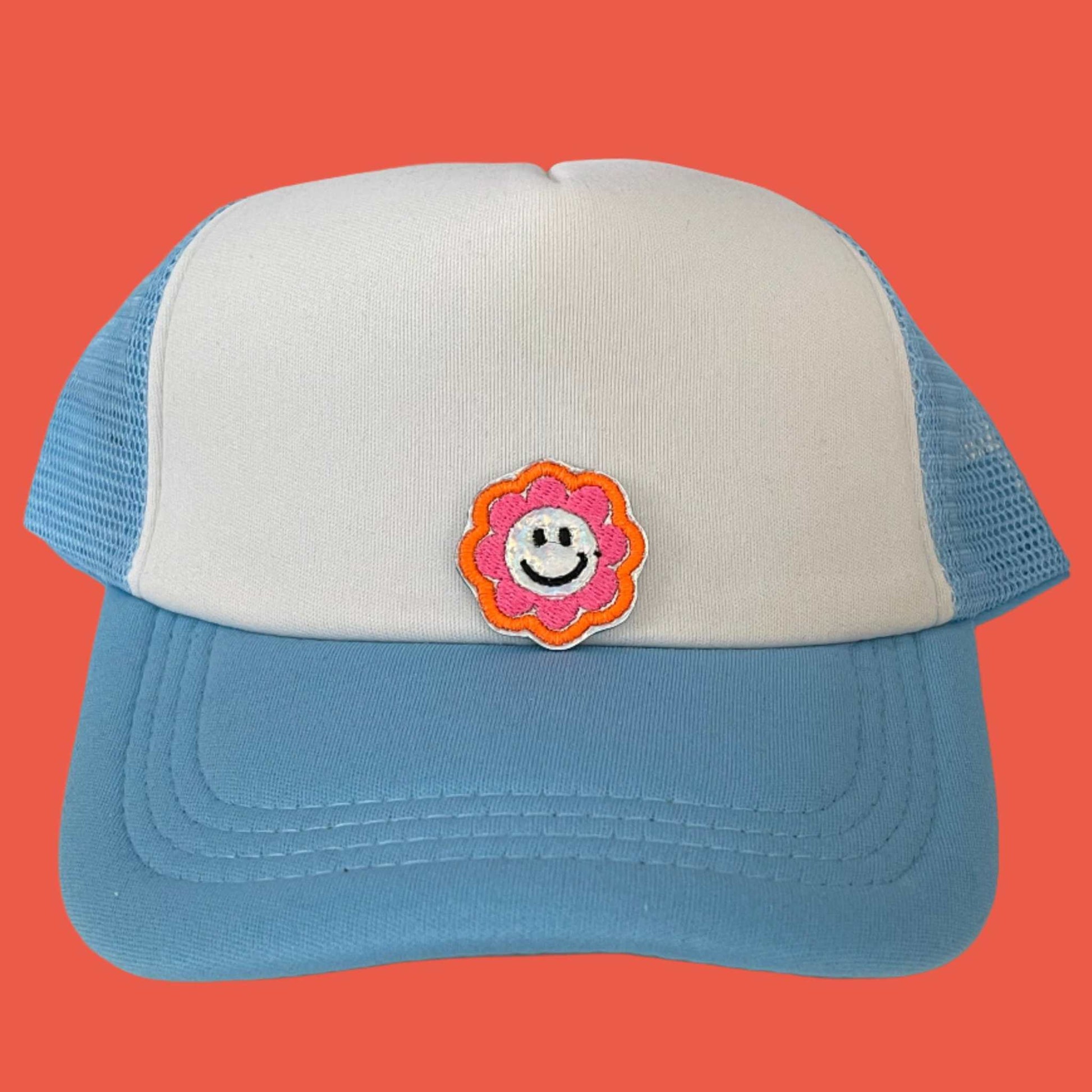 Close-up of a Groovy Smiley Flower embroidered patch featuring a happy yellow smiley face surrounded by colorful flower petals, perfect for customizing hats, apparel, and various accessories.