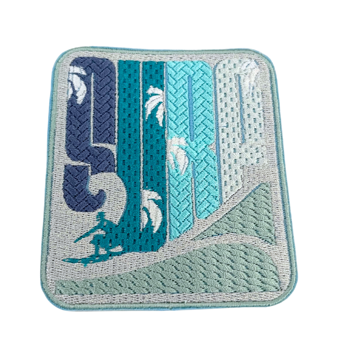 Custom embroidered surf patch with wave and palm tree design, perfect for jackets and hats.