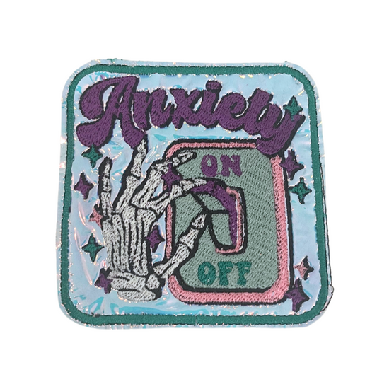 Custom embroidered "Anxiety On" patch with skeleton hand and switch design.