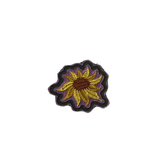 Handmade sunflower patch with color-changing background from green to purple.