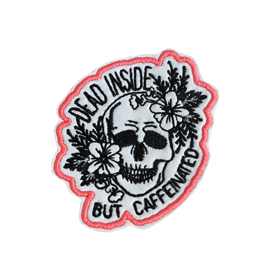 Caffeinated Handmade Patch with skull design and floral accents.