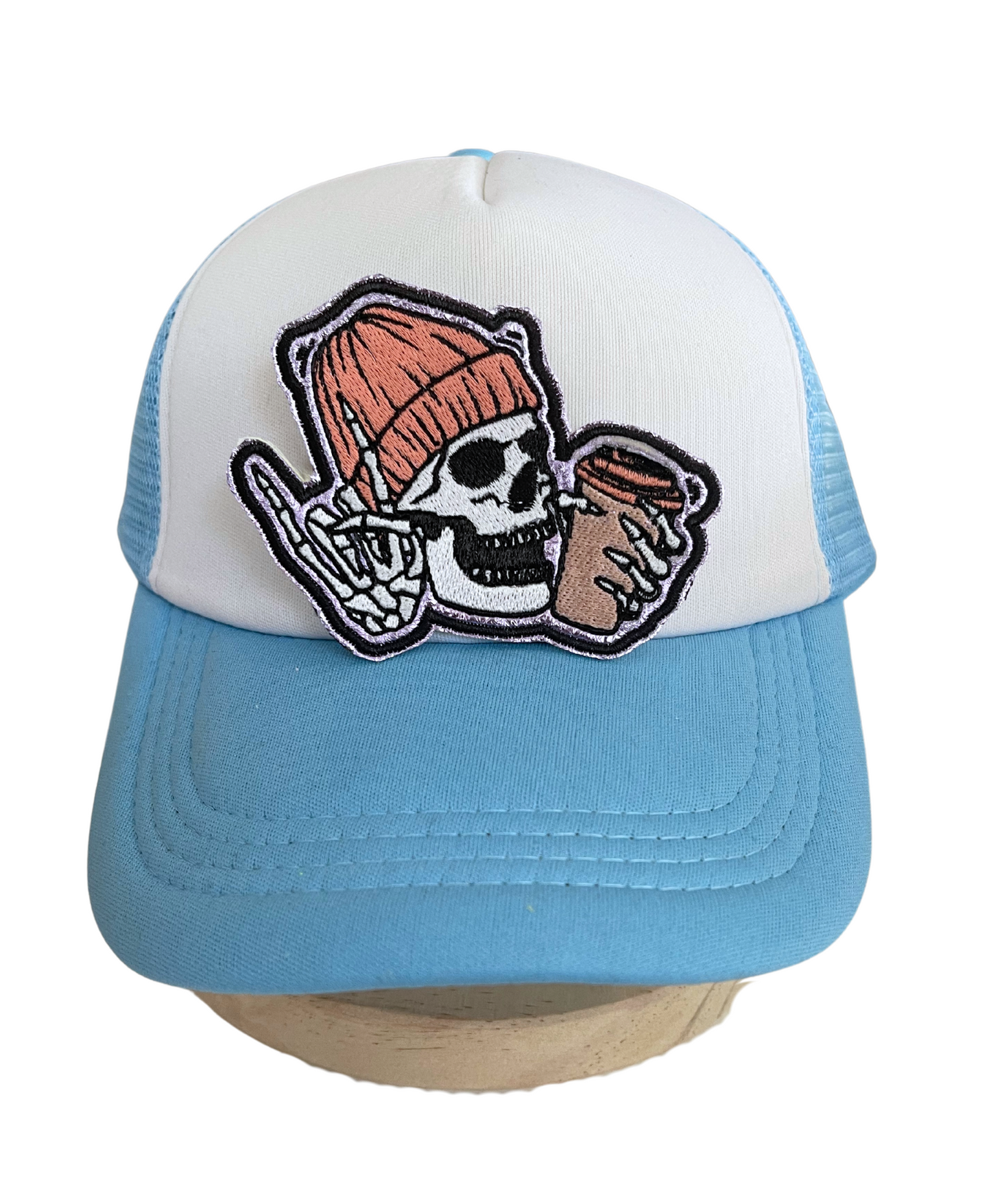 Close-up of Skull Coffee handmade patch, featuring a skull with a beanie and coffee cup.