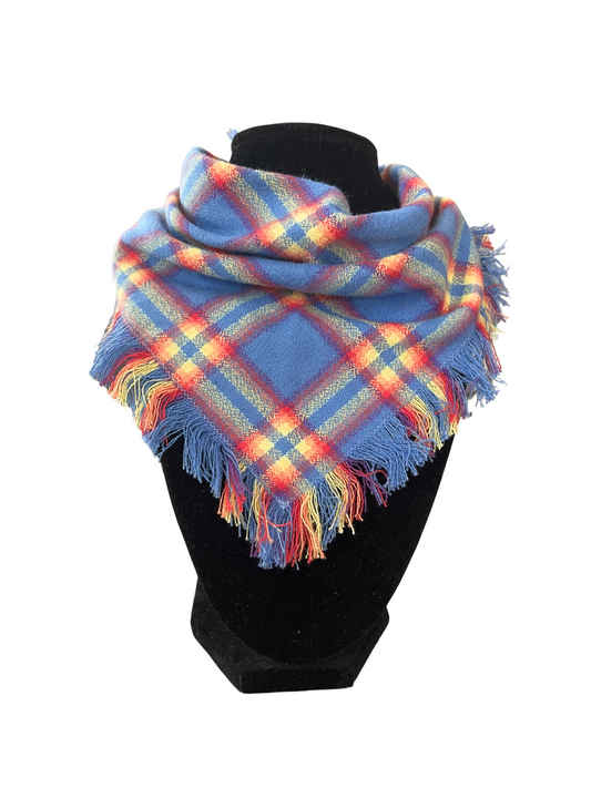 Colorful plaid fringe bib-dana scarf for babies and toddlers on display mannequin.