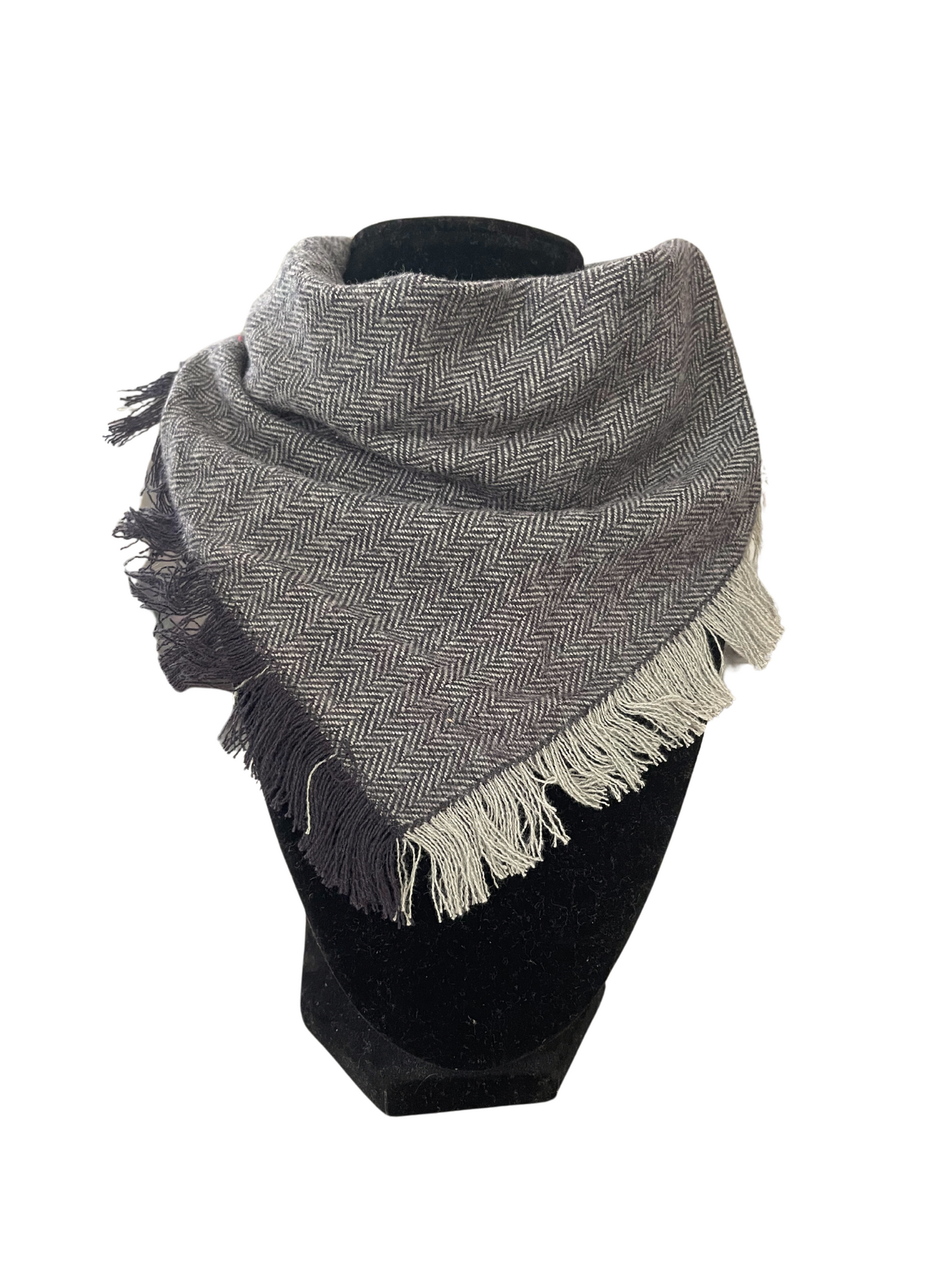 Chic fringe bib-dana scarf in black and gray herringbone pattern with fringes, adjustable snap closure.