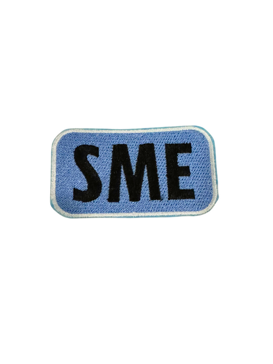 SME PATCH BLACK on blue fabric design.