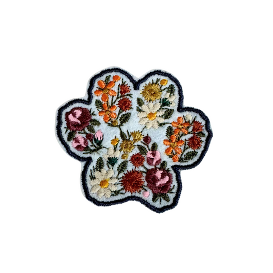 Floral paw print patch with vibrant embroidery, customizable for hats, bags, and accessories.