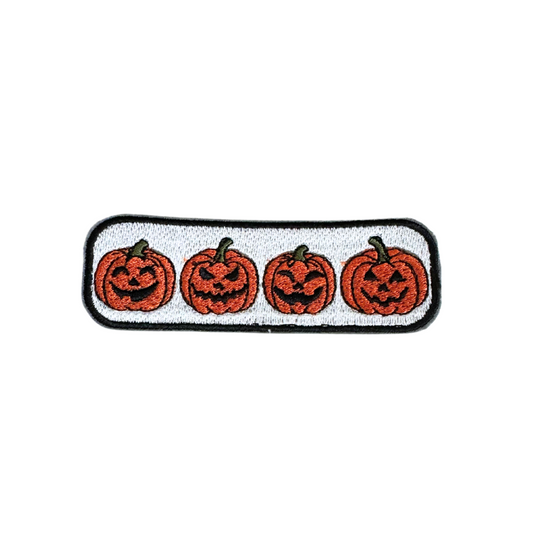 Customizable Jack-O'-Lantern Parade patch with four grinning pumpkins for hats and bags.