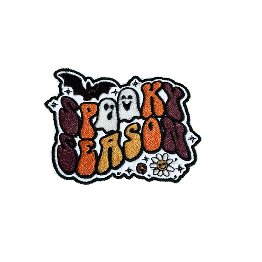 Spooky Season Retro Halloween Patch with playful ghosts, bat, and daisy, 70s style.