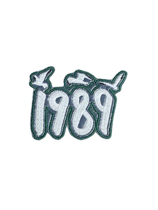 Handmade Taylor Swift "1989" iron-on patch in pink and white with whimsical design.