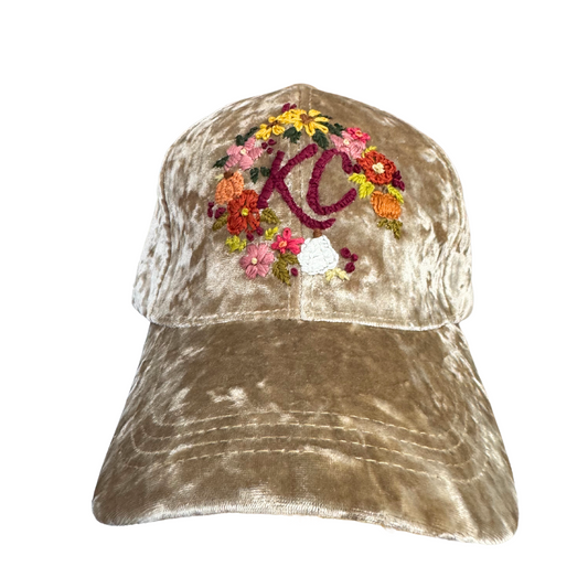 Beige velvet KC hat with hand-embroidered floral design.