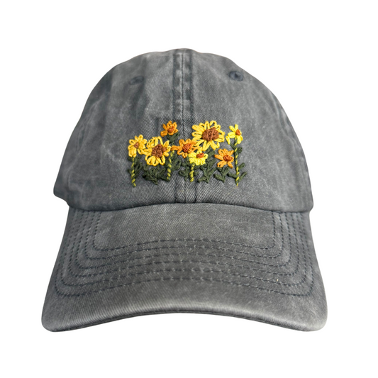 Hand-embroidered sunflower design on grey baseball cap, handmade in Kansas City.