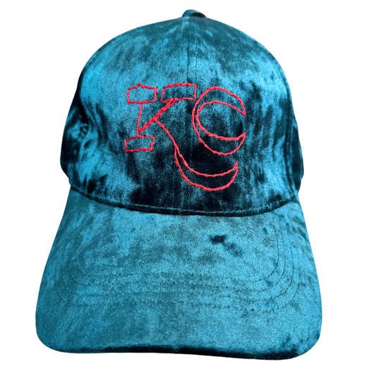 Teal velvet KC hat with hand-embroidered red KC logo in Kansas City Current colors.