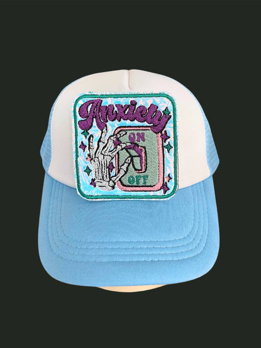 Custom embroidered patch with the text "Anxiety On" featuring a hand flipping a switch, perfect for personalizing hats and apparel.