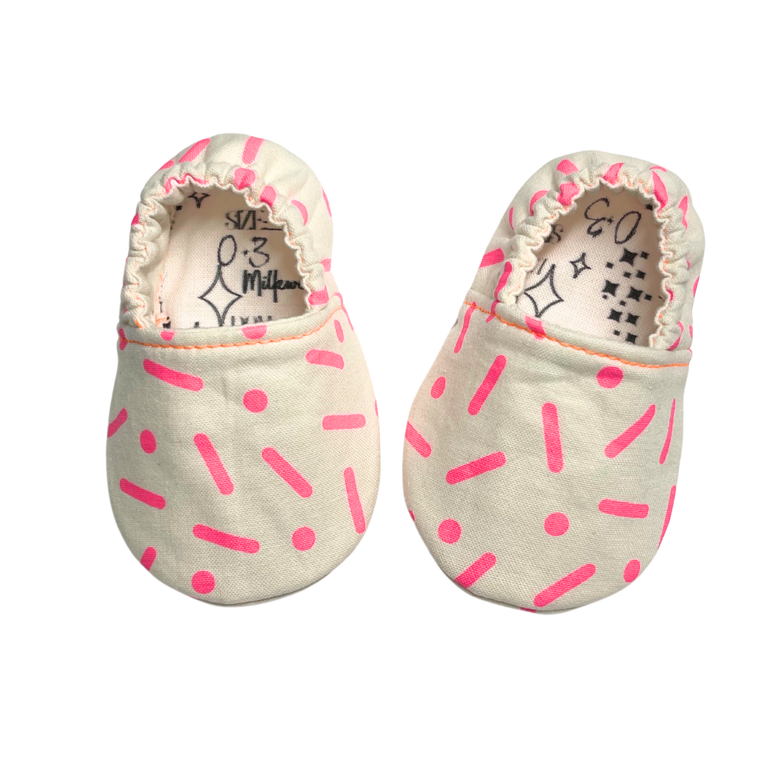 Neon pink sprinkle soft sole baby shoes, handcrafted for proper foot development.