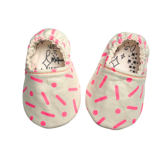 Neon pink sprinkle soft sole baby shoes, handcrafted for proper foot development.