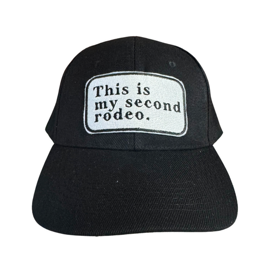 Custom embroidered black cap with "This Is My Second Rodeo" patch, handmade in Kansas City.