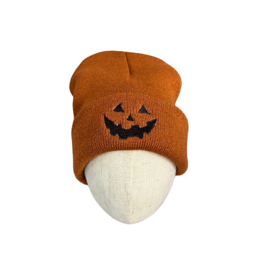 Adult pumpkin Jack-o'-Lantern Halloween beanie hat, orange with embroidered grinning face, cozy and stylish.