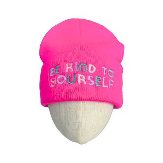 Neon pink embroidered beanie with "Be Kind to Yourself" message.