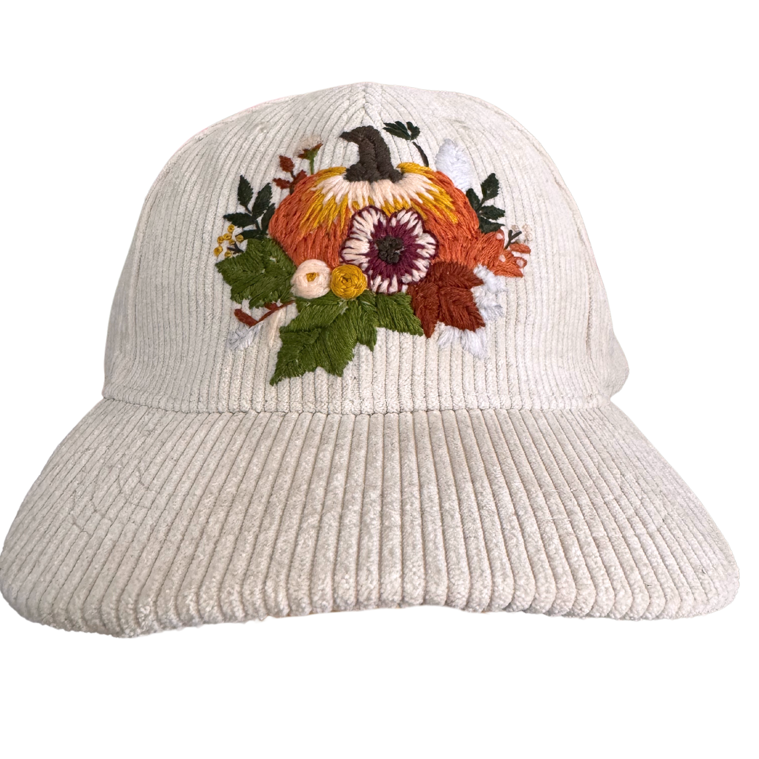 Cream corduroy hat with hand-embroidered pumpkin and floral fall design.