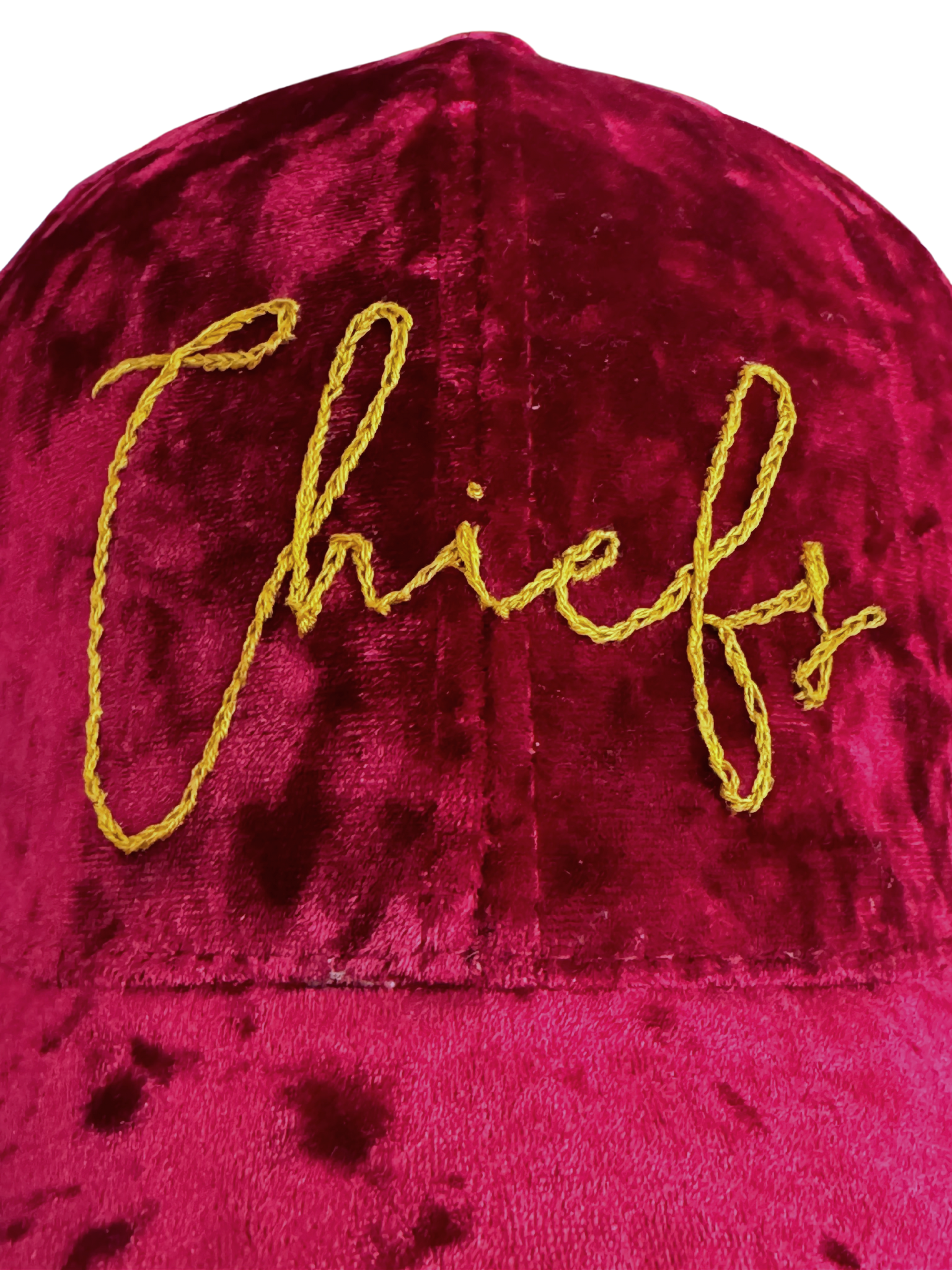 Hand-embroidered "Chiefs" design on red velvet hat.

