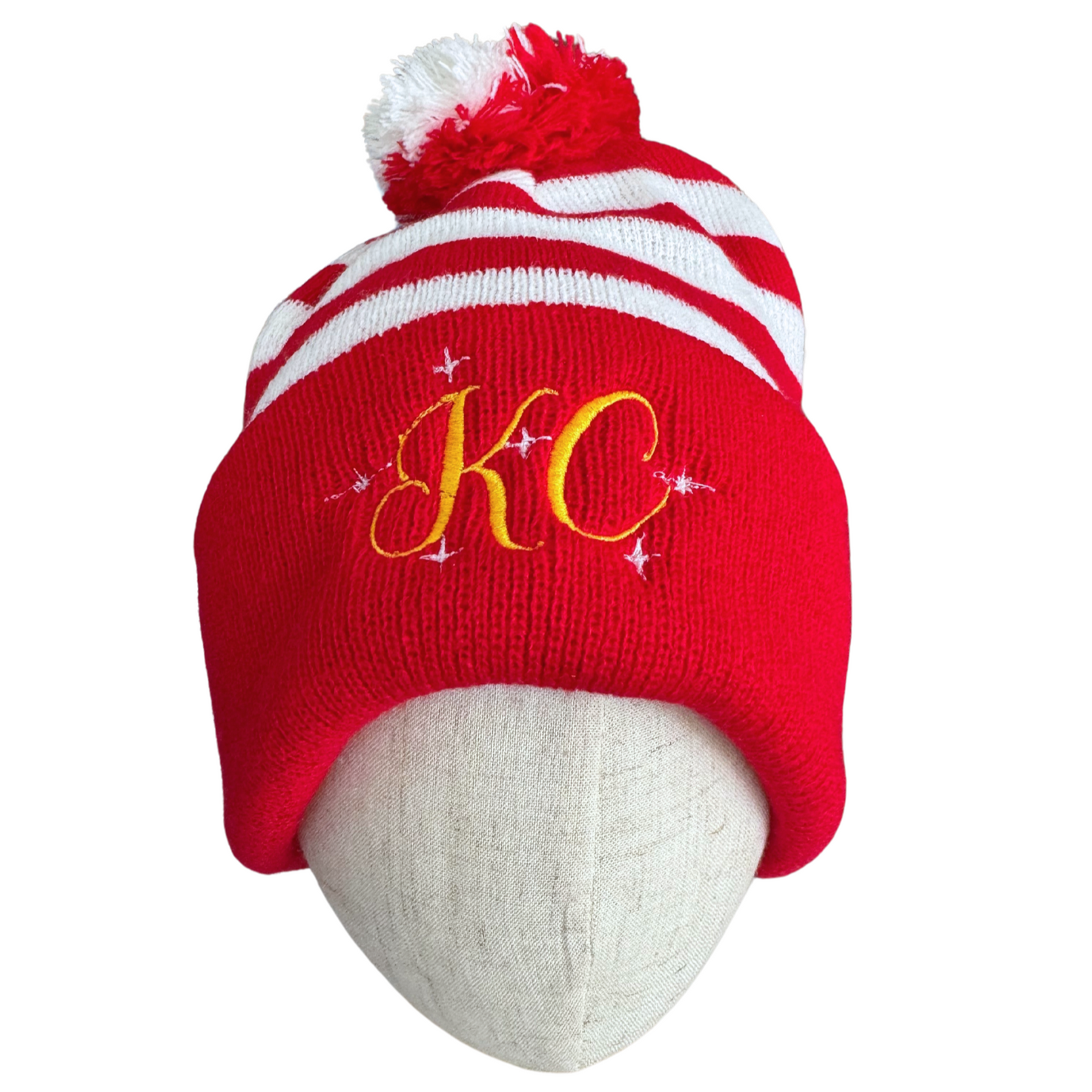 KC Candy Stripe festive beanie in red and white with gold embroidery and pom-pom, perfect for Chiefs fans.