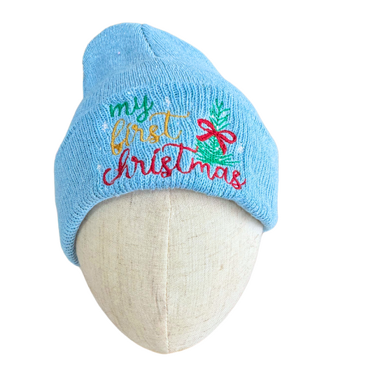 Light blue knit baby beanie with "my first Christmas" embroidery and festive tree design.