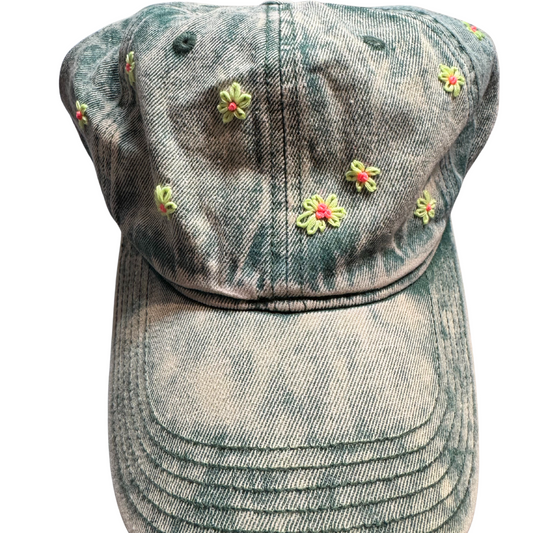 Denim cap with floral embellishments on a white background