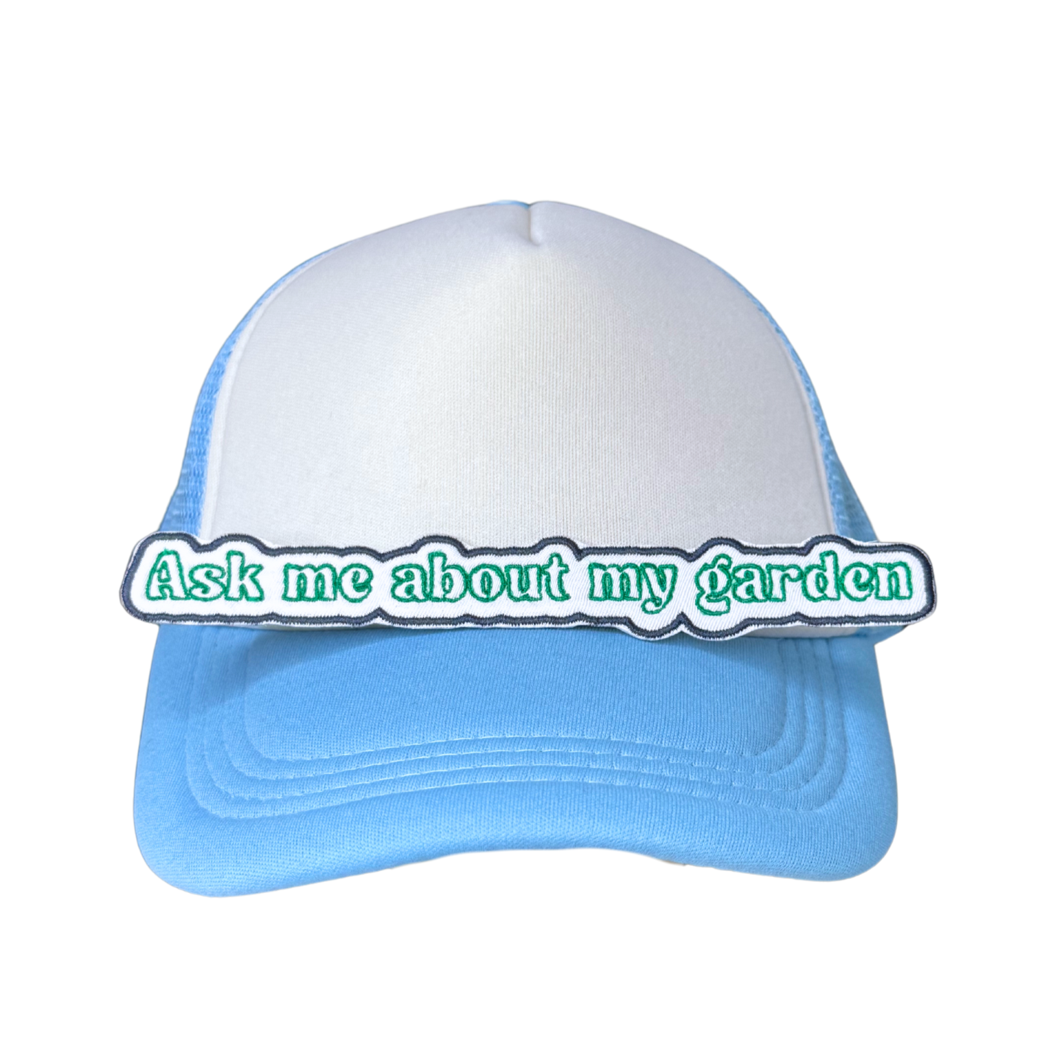 Lifestyle shot of the patch ironed onto a white and blue trucker hat

