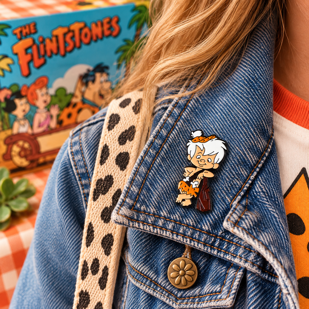 Bamm-Bamm Rubble enamel pin styled on denim jacket