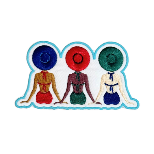 Iron-on embroidered patch featuring three women in swimsuits and sun hats with blue border
