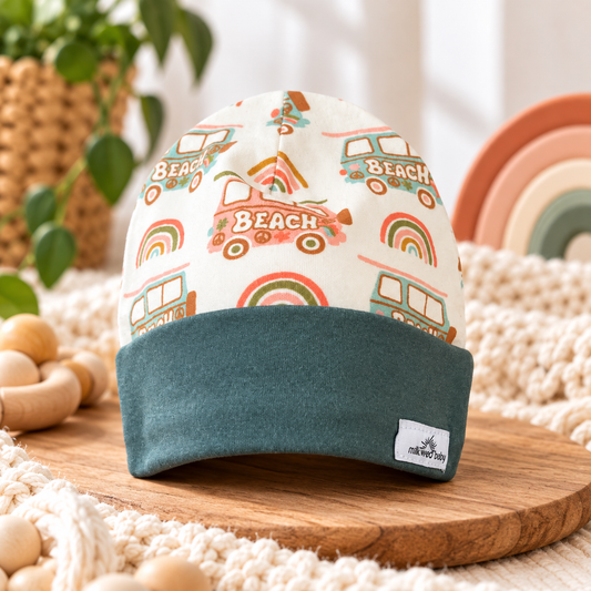Organic cotton baby beanie with retro beach vans, rainbows and teal folded cuff, styled hero