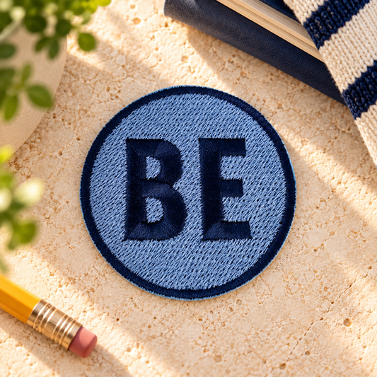 Blue and navy Belinder Elementary BE embroidered iron-on patch, styled hero photo