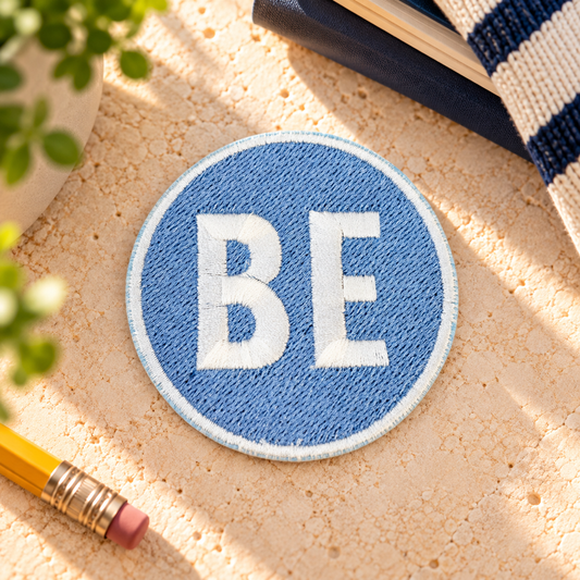 Belinder Elementary BE light blue and white embroidered iron-on patch, styled hero photo