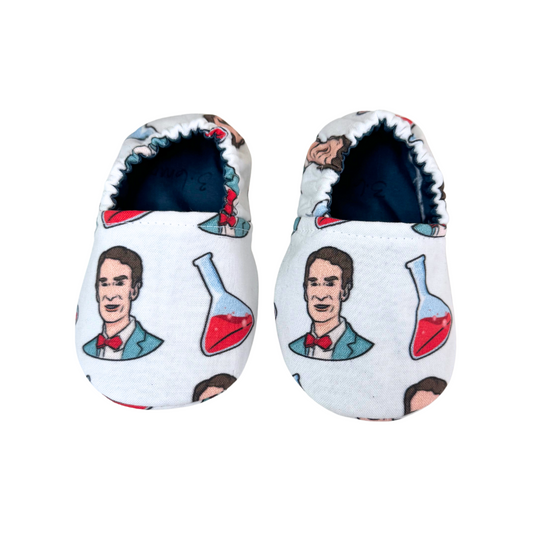 “Handmade soft sole baby shoes featuring Bill Nye print, front view, size 3-6 months”

