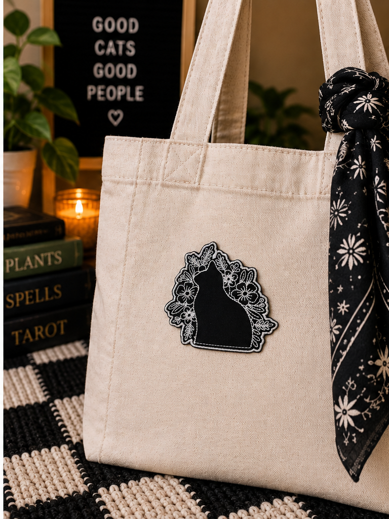Black Cat Floral embroidered patch styled on a cream canvas tote