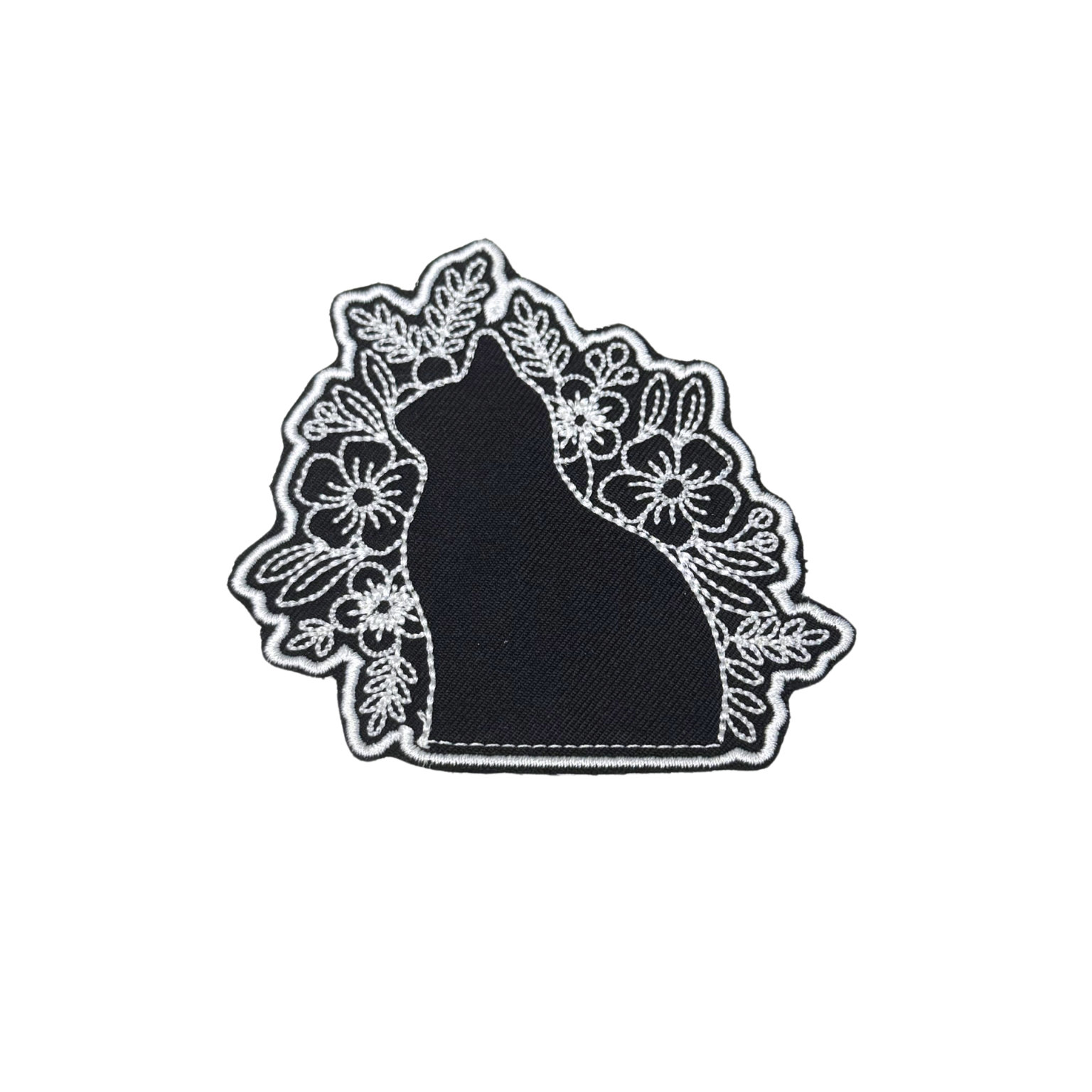 Black silhouette cat patch with floral white embroidery details
