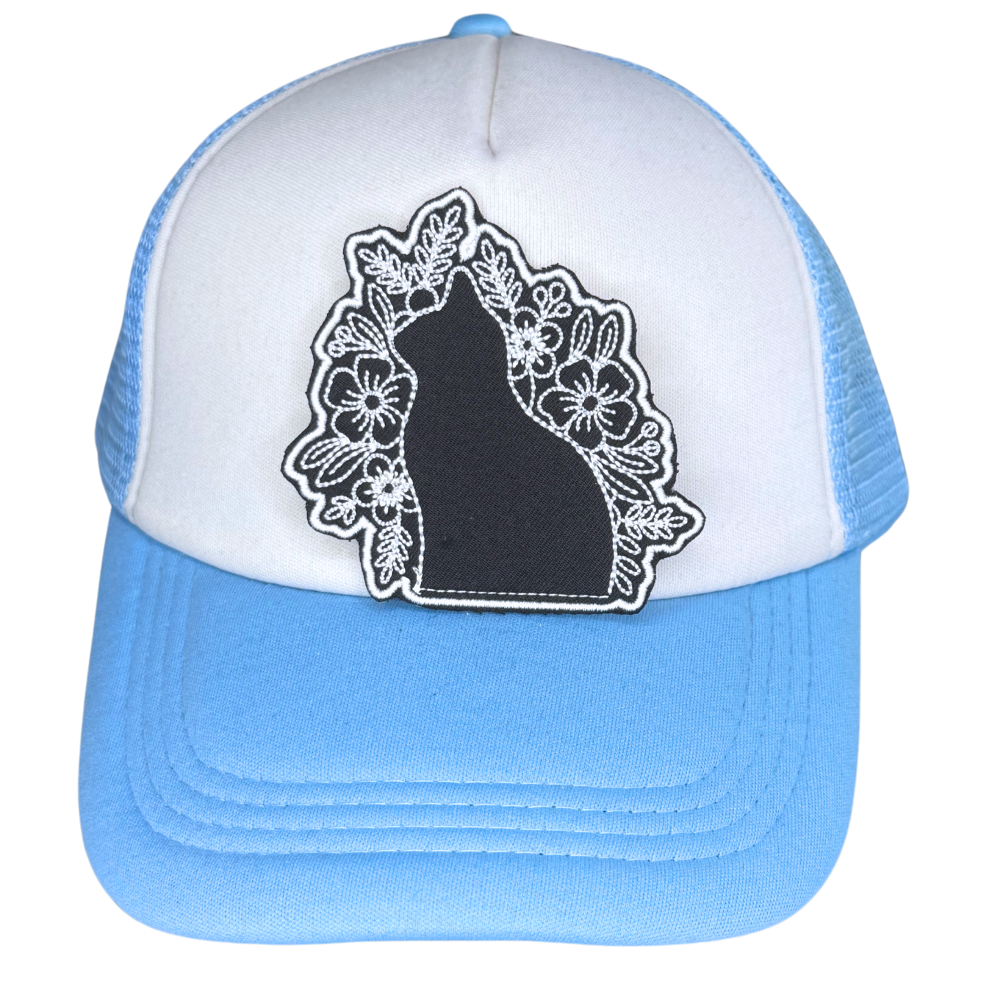 Black and white embroidered cat patch on blue and white trucker hat

