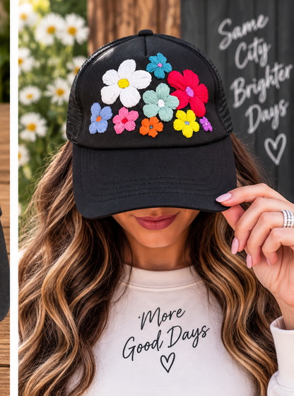 Model wearing black hand-embroidered floral trucker hat