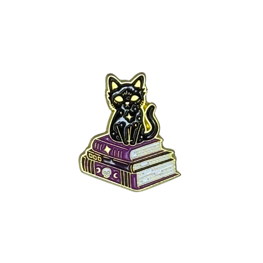 “Black cat on stack of books enamel pin”


