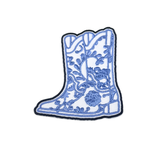 Blue and white embroidered cowboy boot patch with floral detail
