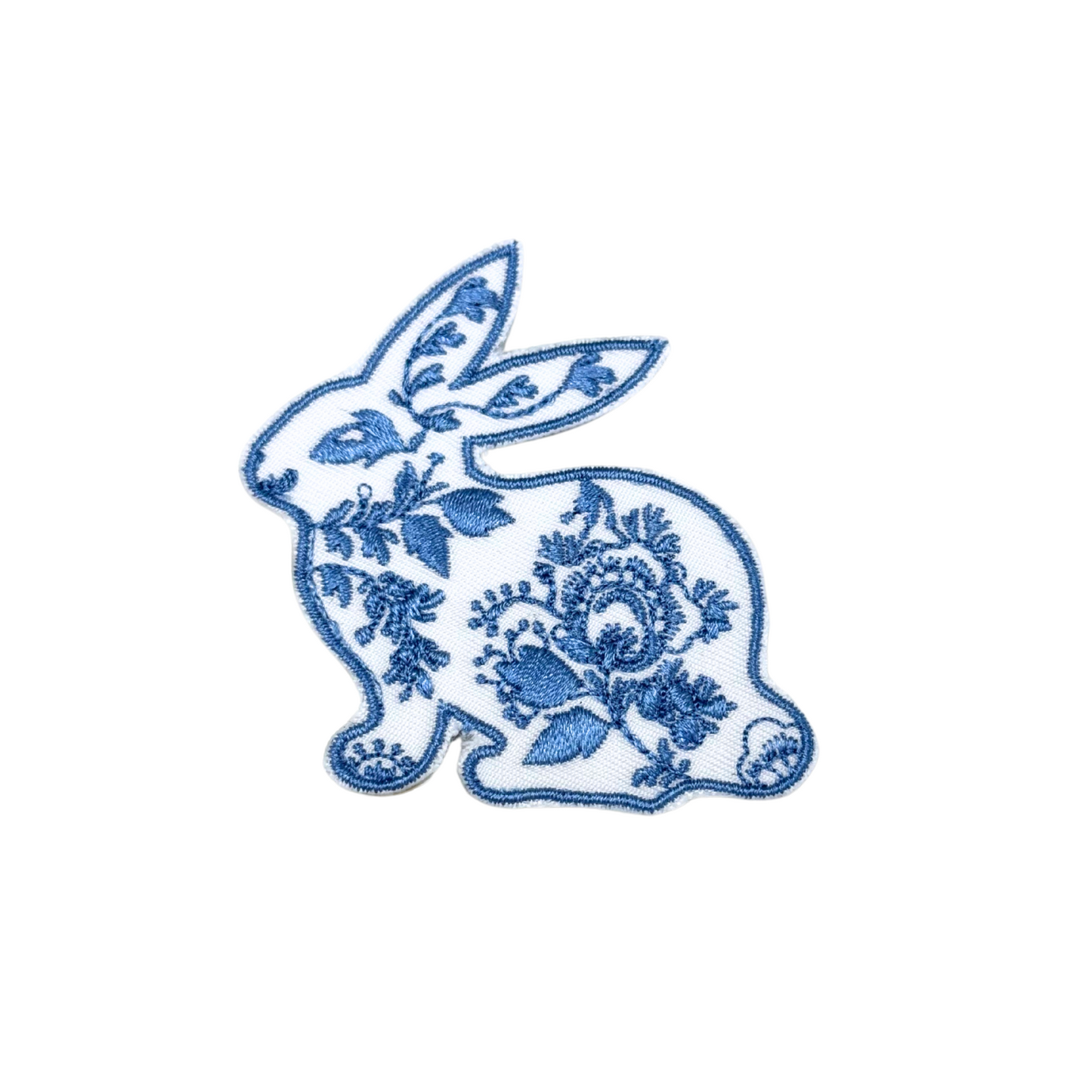 Front view of a blue and white floral bunny embroidered iron-on patch
