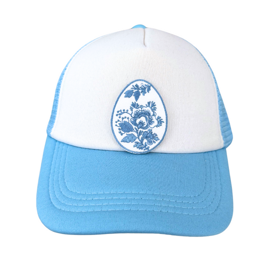 Blue floral egg patch ironed on white and blue trucker hat
