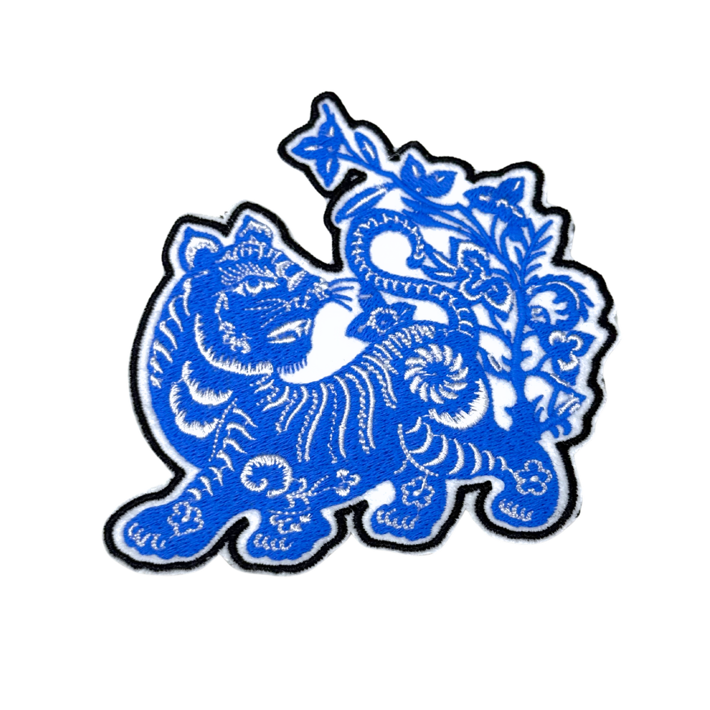 Closeup of vibrant blue embroidered tiger patch showing detailed stitching